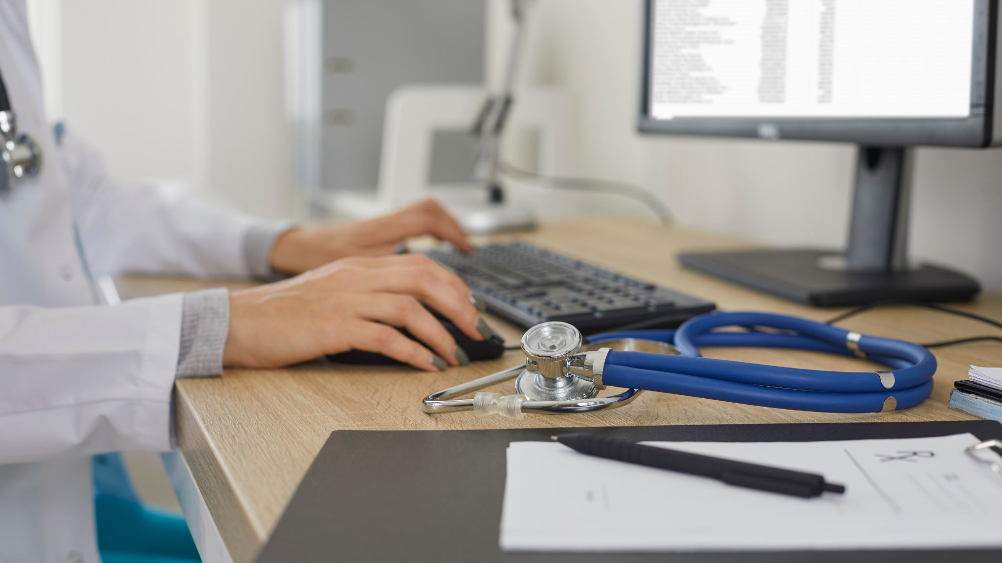 doctor typing on a computer